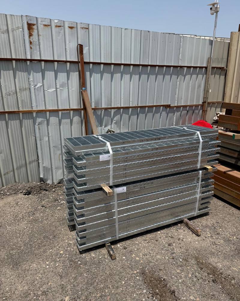 Galvanised grating panels stacked on site